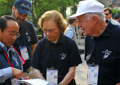 The Carters review election paperwork in Nepal